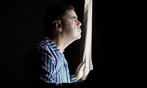 man looking a the window | hoa tree trimming