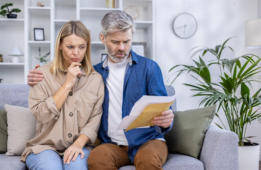 worried couple | types of hoa fines