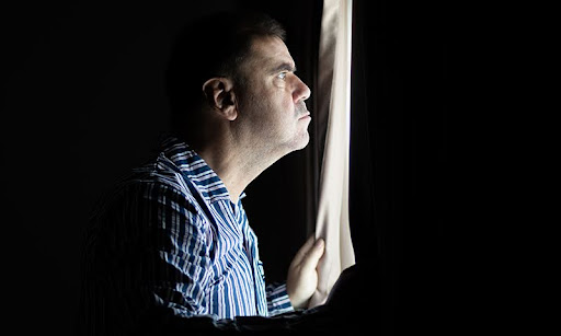man looking a the window | hoa tree trimming
