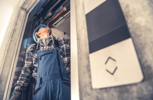 Professional technician fixing elevator doors | HOA ADA Compliance