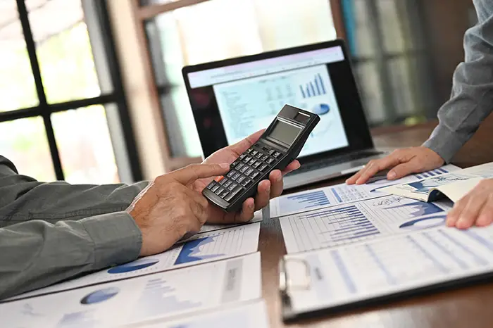 man using a calculator | vacant lots in hoa